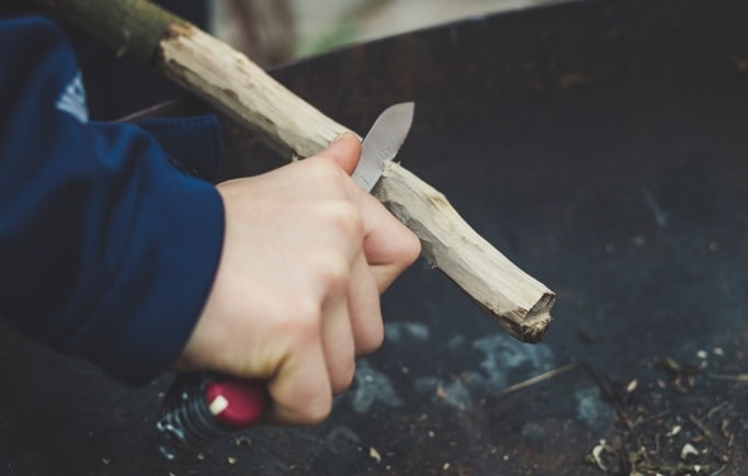 Crafting tinder using a pocket knife for fire starting