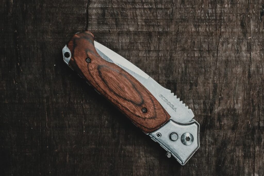 rustic pocket knife on wooeden background