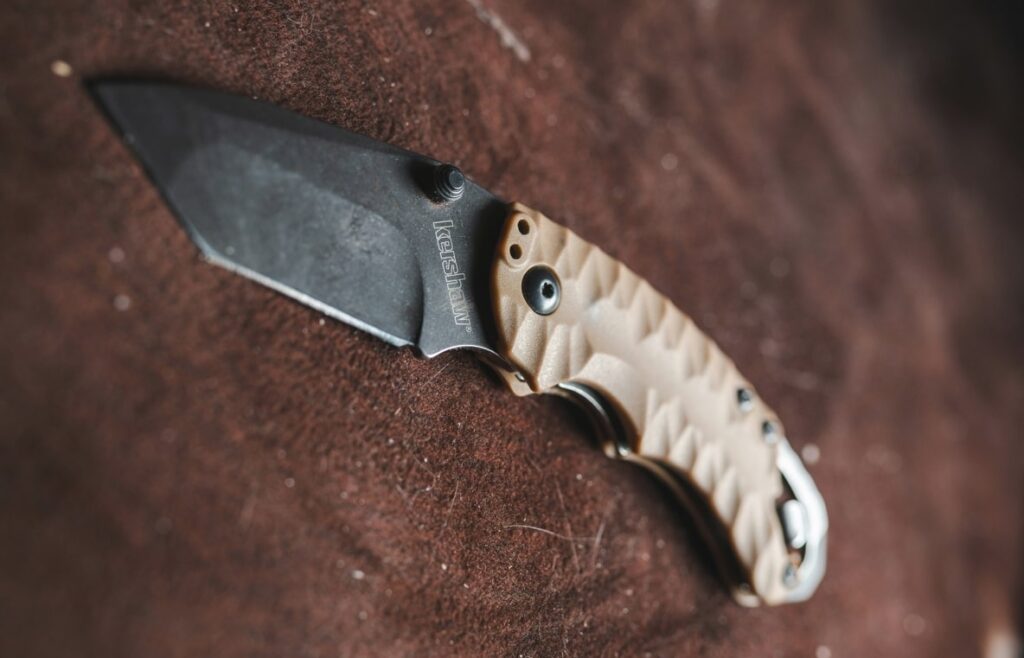 american tanto blade made by kershaw on top of a sheath