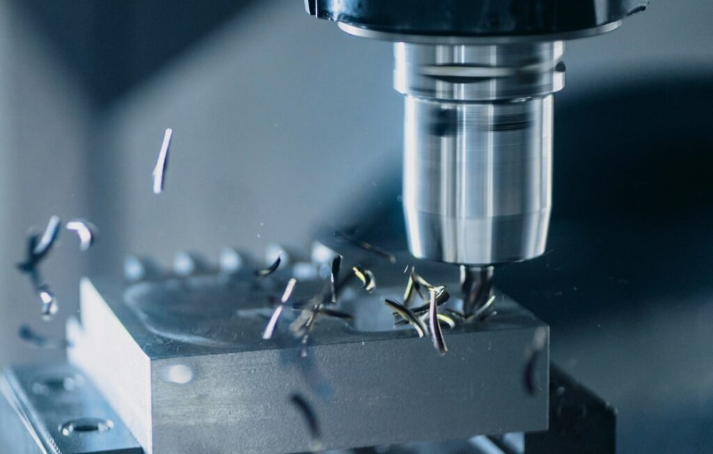 CNC machine working on shaping a knife during the early steps